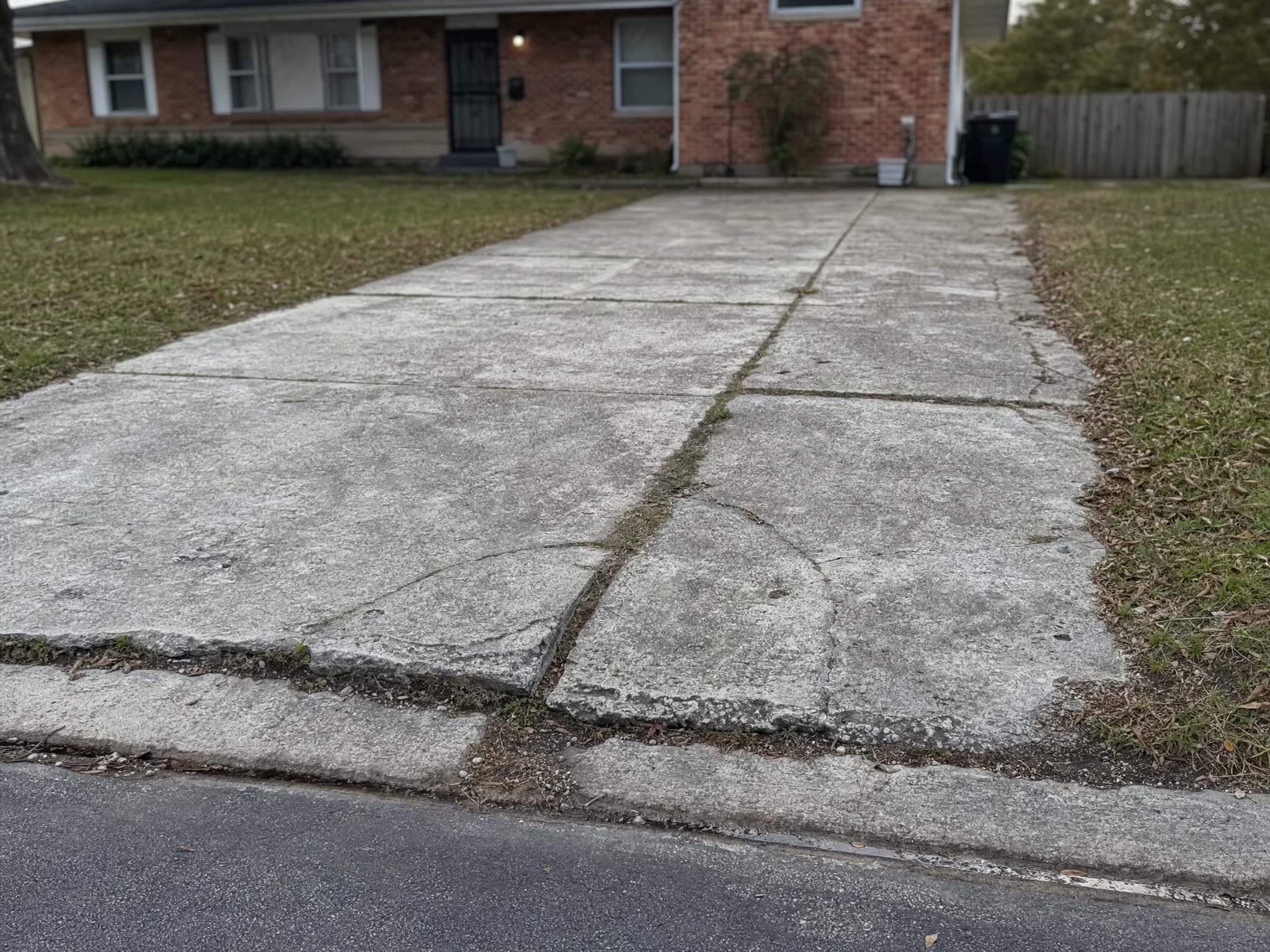 Driveway before: cracked, heaving concrete slabs